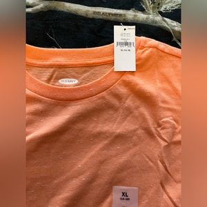 Plain orange shirt with white specs or marks all over. Never worn.
